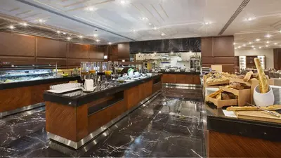 a large kitchen with a counter in a restaurant at DoubleTree by Hilton Istanbul-Avcilar in Istanbul