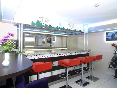 a restaurant with red bar stools and a counter at Hotel Timya in Istanbul