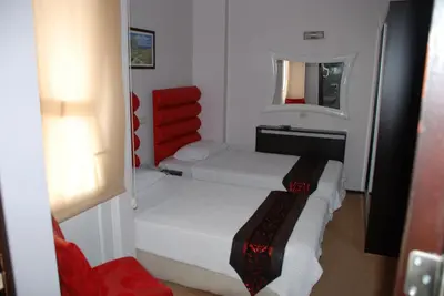 a small room with two beds and a mirror at Hotel Timya in Istanbul