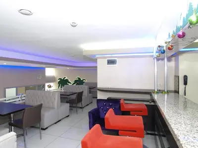 a restaurant with red chairs and a bar at Hotel Timya in Istanbul