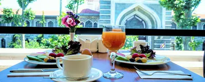a table with two plates of food and a glass of juice at Boss Hotel Sultanahmet in Istanbul