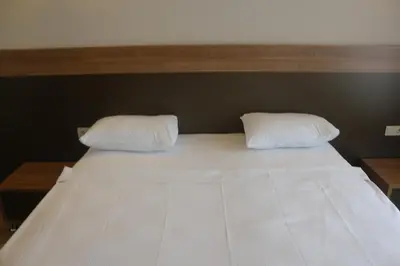 a bed with two white pillows on top of it at Longoz Hotel in Igneada