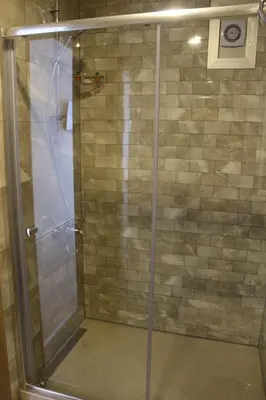 a shower with a glass door in a bathroom at Longoz Hotel in Igneada