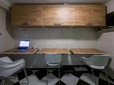 a kitchen with a table with a laptop on it at Taksim Hostel Green House Istanbul in Istanbul
