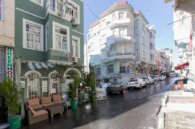 a city street with buildings on a rainy day at Taksim Hostel Green House Istanbul in Istanbul