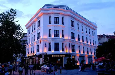 a white building on a street with people walking around it at Mirart Hotel Boutique & SPA Yalova in Yalova