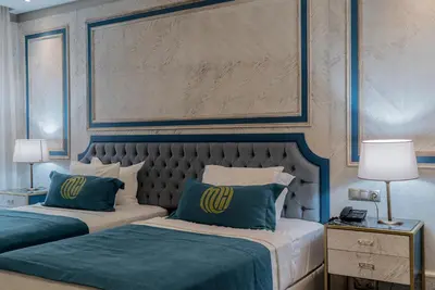 a bedroom with two beds with blue and white at Mirart Hotel Boutique & SPA Yalova in Yalova