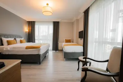 a hotel room with two beds and a window at Asia City Hotel Istanbul in Istanbul
