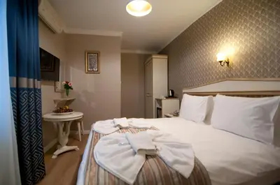 a bedroom with a bed with a bow on it at Mevlana Hotel in Istanbul