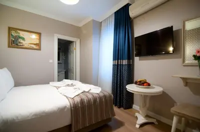 a hotel room with a bed and a table with fruit on it at Mevlana Hotel in Istanbul