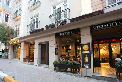 a store front of a street with people sitting outside at Taksim Premium Hotel in Istanbul