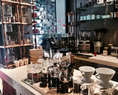 a kitchen with glasses and dishes on a counter at Taksim Premium Hotel in Istanbul