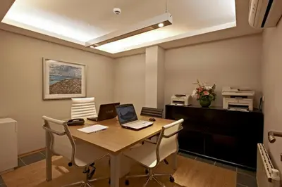 an office with a desk with a laptop and chairs at Retropera Hotel in Istanbul