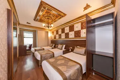 a hotel room with two beds and a chandelier at VERSİON HOTEL in Istanbul