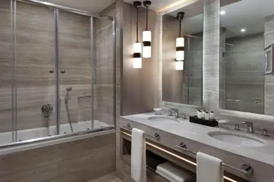 a bathroom with two sinks and a shower at Sheraton Istanbul City Center in Istanbul