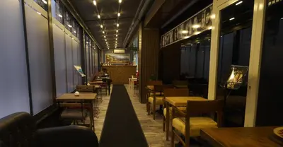 a restaurant with tables and chairs and lights at Florya House Hotel in Istanbul