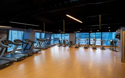 a gym with rows of treadmills and ellipticals at Windsor Hotel & Convention Center Istanbul in Istanbul