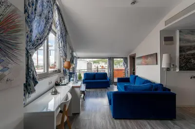 a living room with blue chairs and a table at Elanaz Hotel in Istanbul