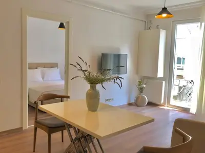 a living room with a table with a vase on it at Joy Suites in Istanbul
