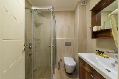 a bathroom with a shower and a toilet and a sink at Joy Suites in Istanbul