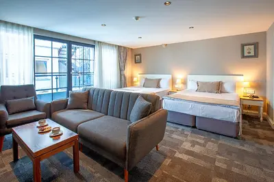 a hotel room with a bed and a couch and a bed at Aston Hotel Taksim in Istanbul