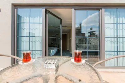a glass table with two glasses on top of it at Aston Hotel Taksim in Istanbul