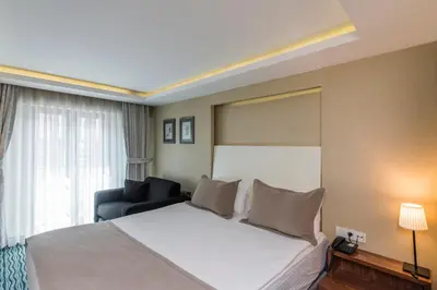 a hotel room with a bed and a chair at Aston Hotel Taksim in Istanbul