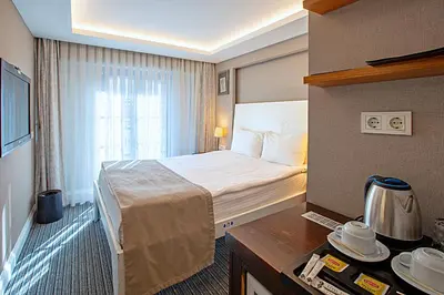a hotel room with a large bed and a table at Aston Hotel Taksim in Istanbul