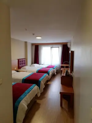 a row of beds in a hotel room at BURSA ŞAHiN HOTEL in Bursa