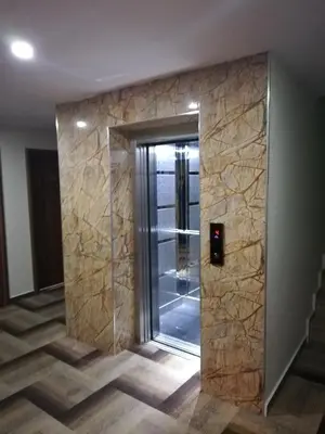 a glass elevator in a room with a glass door at BURSA ŞAHiN HOTEL in Bursa
