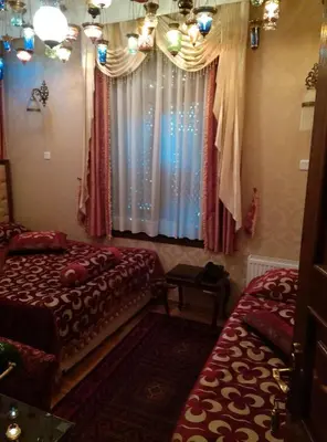 a bedroom with two beds and a window at Kybele Hotel in Istanbul