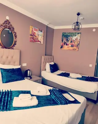 a bedroom with two beds with towels on them at Hotel Estambul in Istanbul