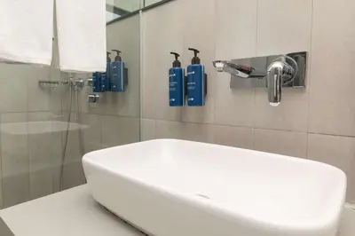 a bathroom with a white sink and a shower at Radisson Blu Hotel Istanbul Asia in Istanbul
