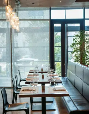 a dining room with tables and chairs with wine glasses at Radisson Blu Hotel Istanbul Asia in Istanbul