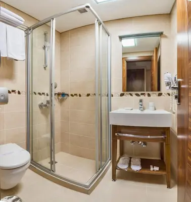 a bathroom with a shower and a sink and a toilet at The Meretto Hotel Istanbul Old City in Istanbul