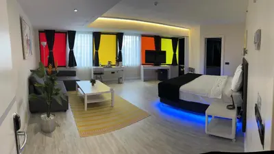 a bedroom with a bed and a desk and a tv at Tempo Hotel Caglayan in Istanbul
