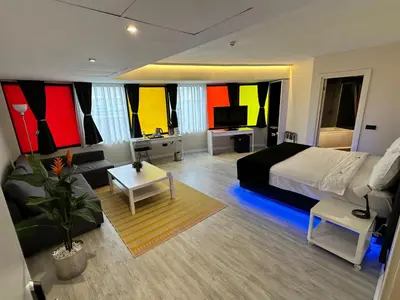 a bedroom with a bed and a living room at Tempo Hotel Caglayan in Istanbul
