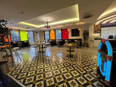 a lobby with a room with tables and chairs at Tempo Hotel Caglayan in Istanbul