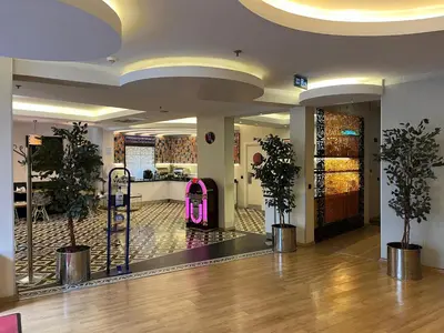 a lobby with two potted plants in a building at Tempo Hotel Caglayan in Istanbul