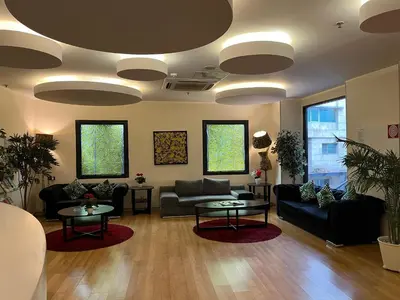 a living room with couches and tables and windows at Tempo Hotel Caglayan in Istanbul