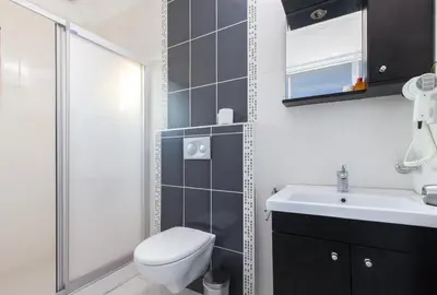 a bathroom with a toilet and a sink and a shower at SUFI APART Otel in Istanbul