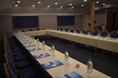 a long table in a room with chairs and water bottles at Rhiss Hotel Bostanci in Istanbul