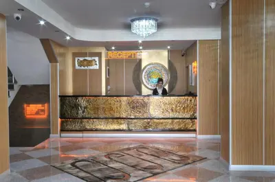 a man standing behind a counter in a lobby at Rhiss Hotel Bostanci in Istanbul