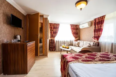 a hotel room with a bed and a couch at The First Ottoman Suites in Istanbul
