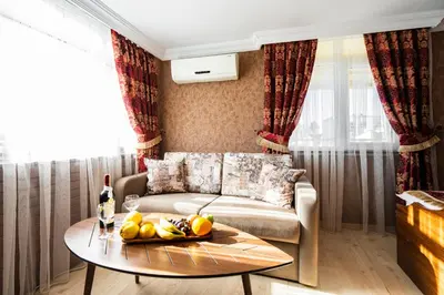 a living room with a couch and a table with fruit on it at The First Ottoman Suites in Istanbul