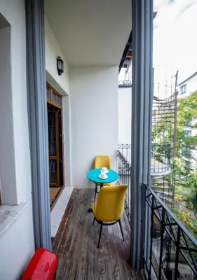 a balcony with a blue table and two yellow chairs at Royal Garden Suite and Hotel in Istanbul