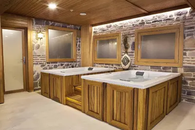 a bathroom with two sinks and a stone wall at Baron Hotel & Spa in Istanbul