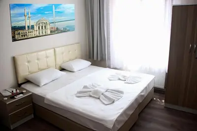 a bedroom with a bed with two towels on it at Marpalace Hotel in Istanbul