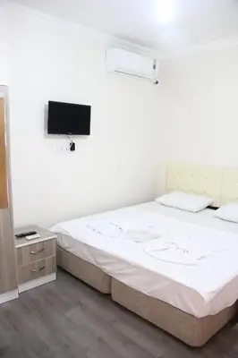 a bedroom with a bed and a tv on the wall at Marpalace Hotel in Istanbul
