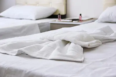 two white beds with white sheets on them at Marpalace Hotel in Istanbul